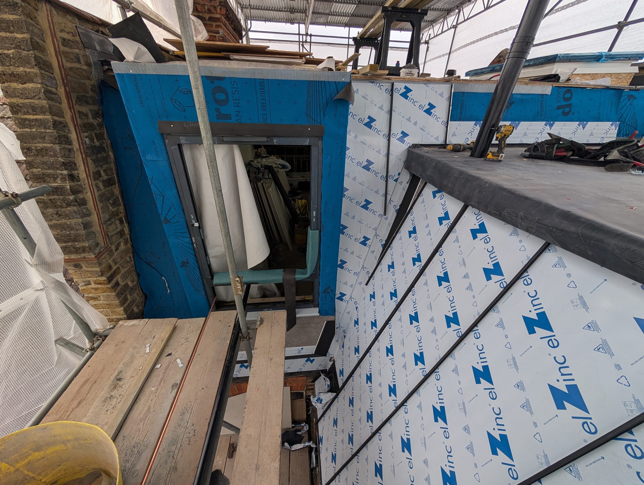 Zinc cladding installation in progress on a loft conversion.